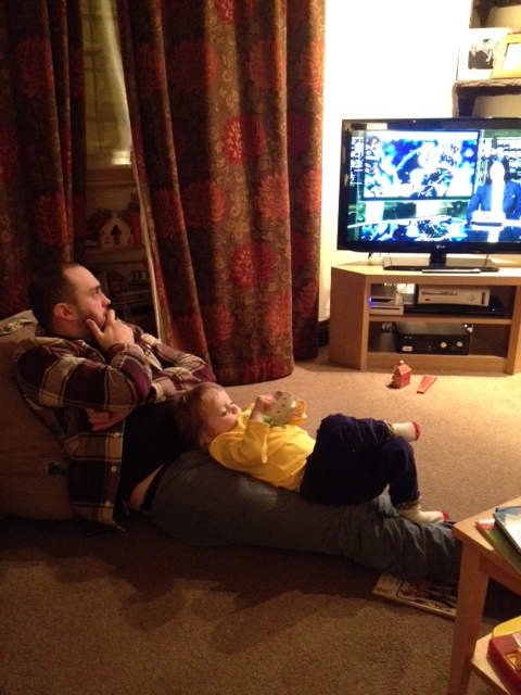 Dad and daughter watching football
