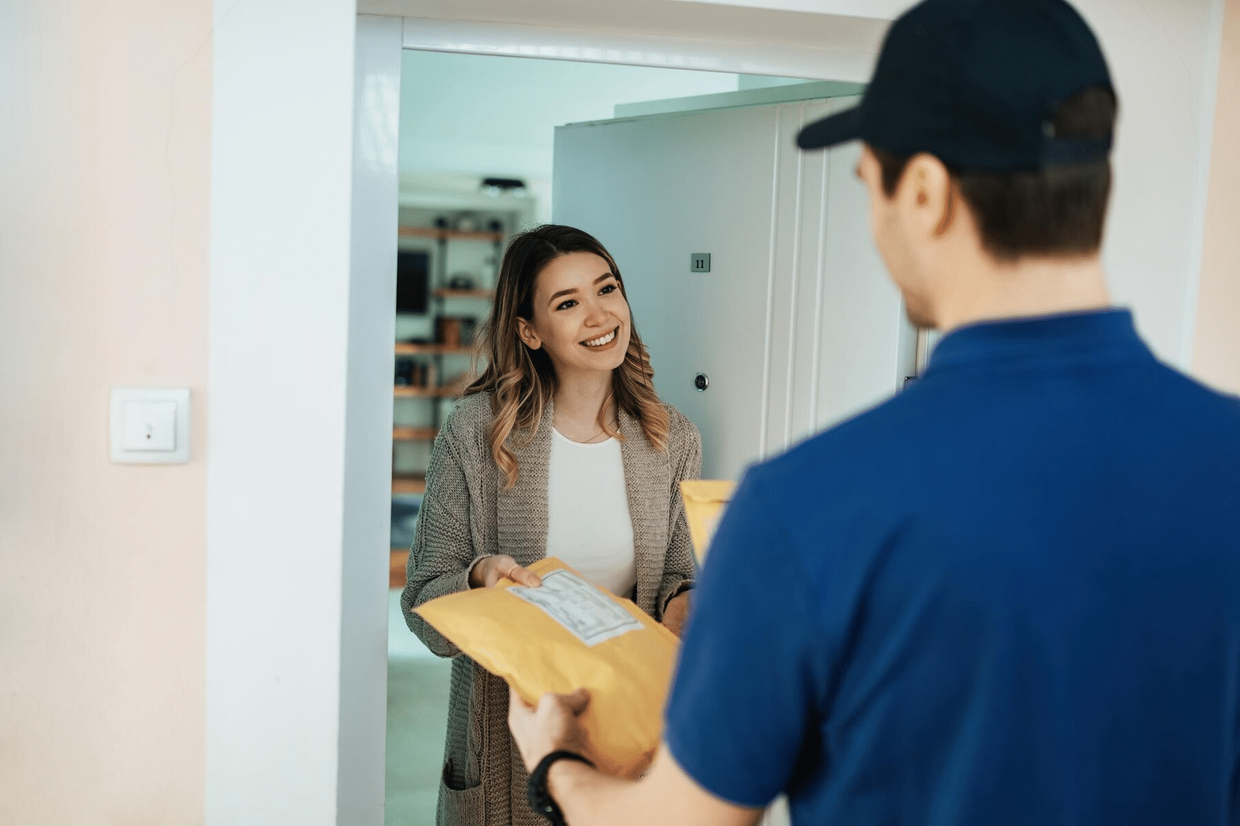 woman taking package from courier