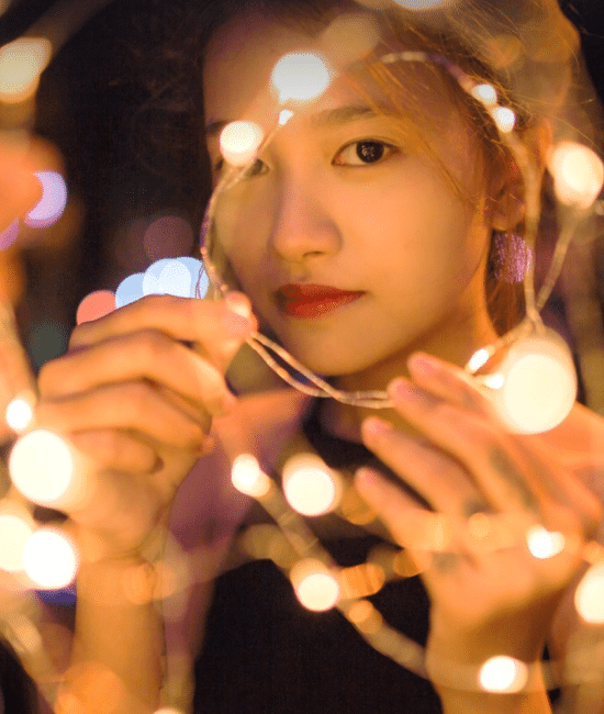 A person holding a string of lights AI-generated content may be incorrect.