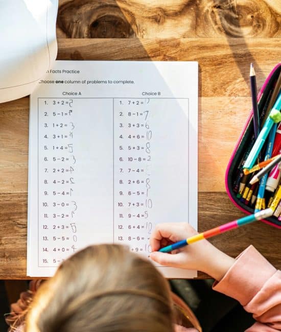 A child writing on a piece of paper AI-generated content may be incorrect.