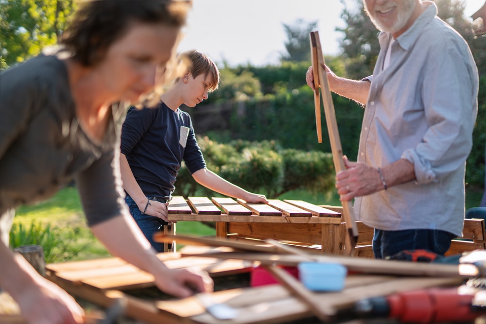 A,Family,Is,Building,Wooden,Containers,For,Their,Vegetable,Garden