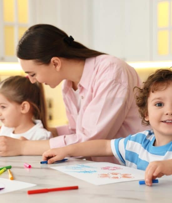 Mother,And,Her,Little,Children,Drawing,With,Colorful,Markers,At