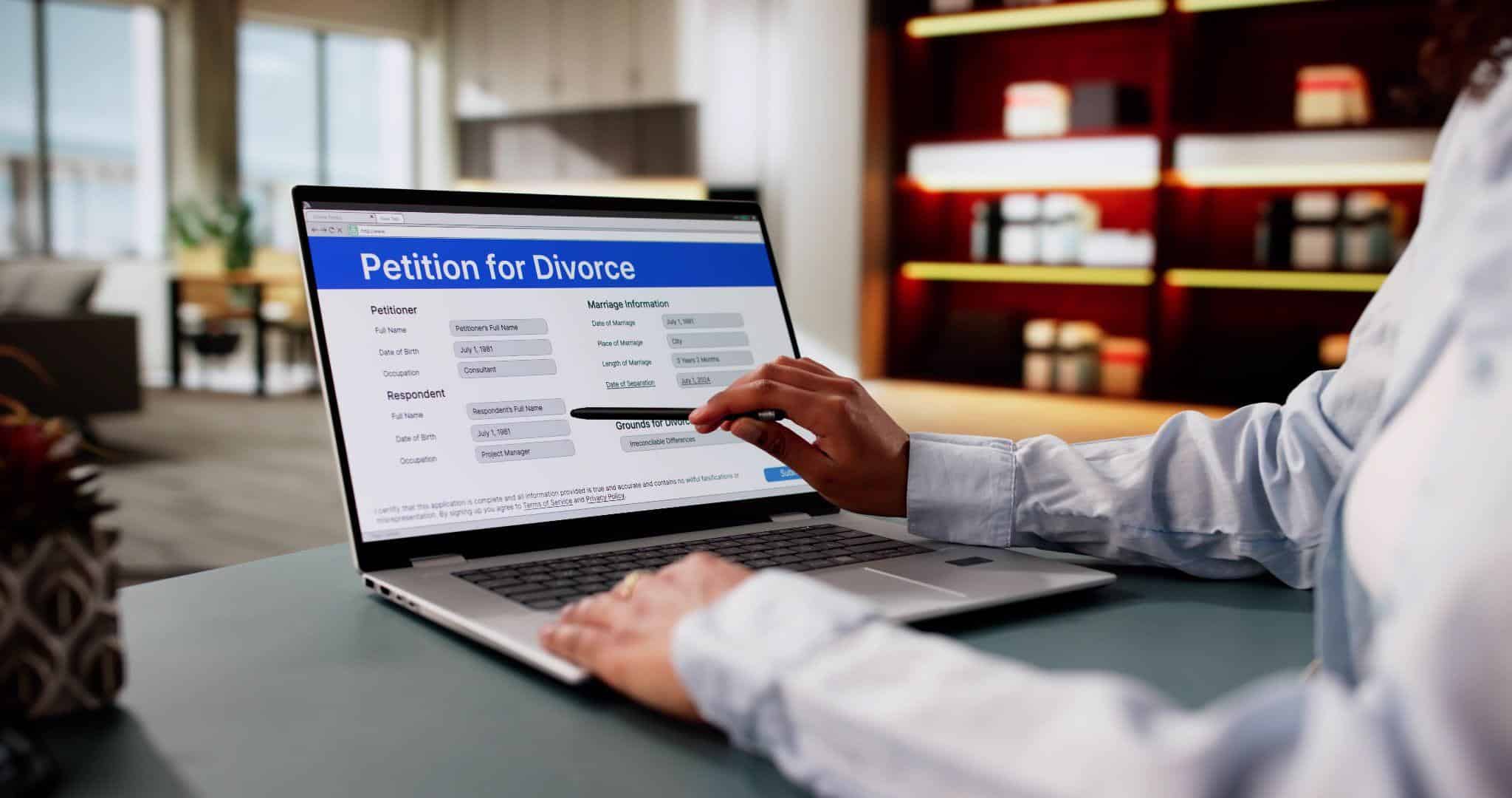 Someone looking at a petition for divorce record on a computer and wondering, “Are divorce records public in Massachusetts?