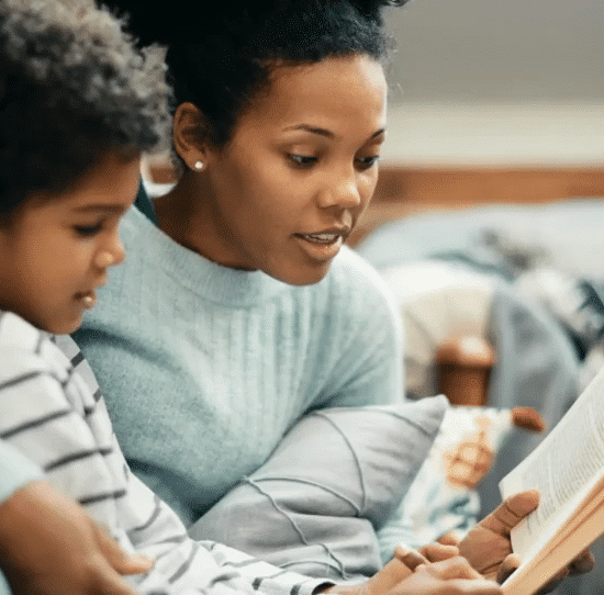 A kid sitting with her mom