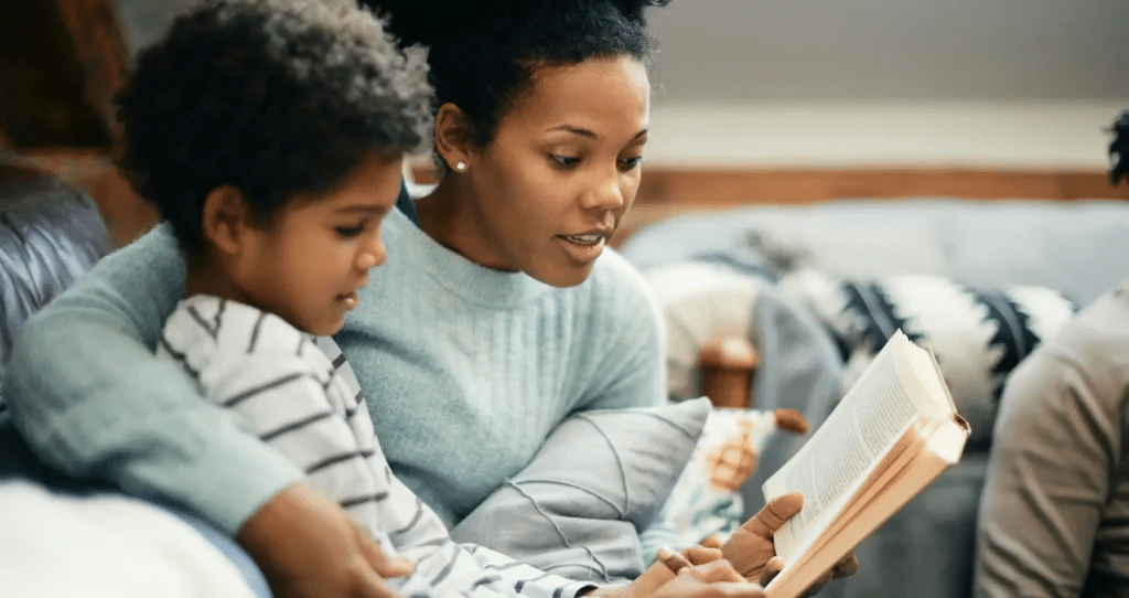 A kid sitting with her mom