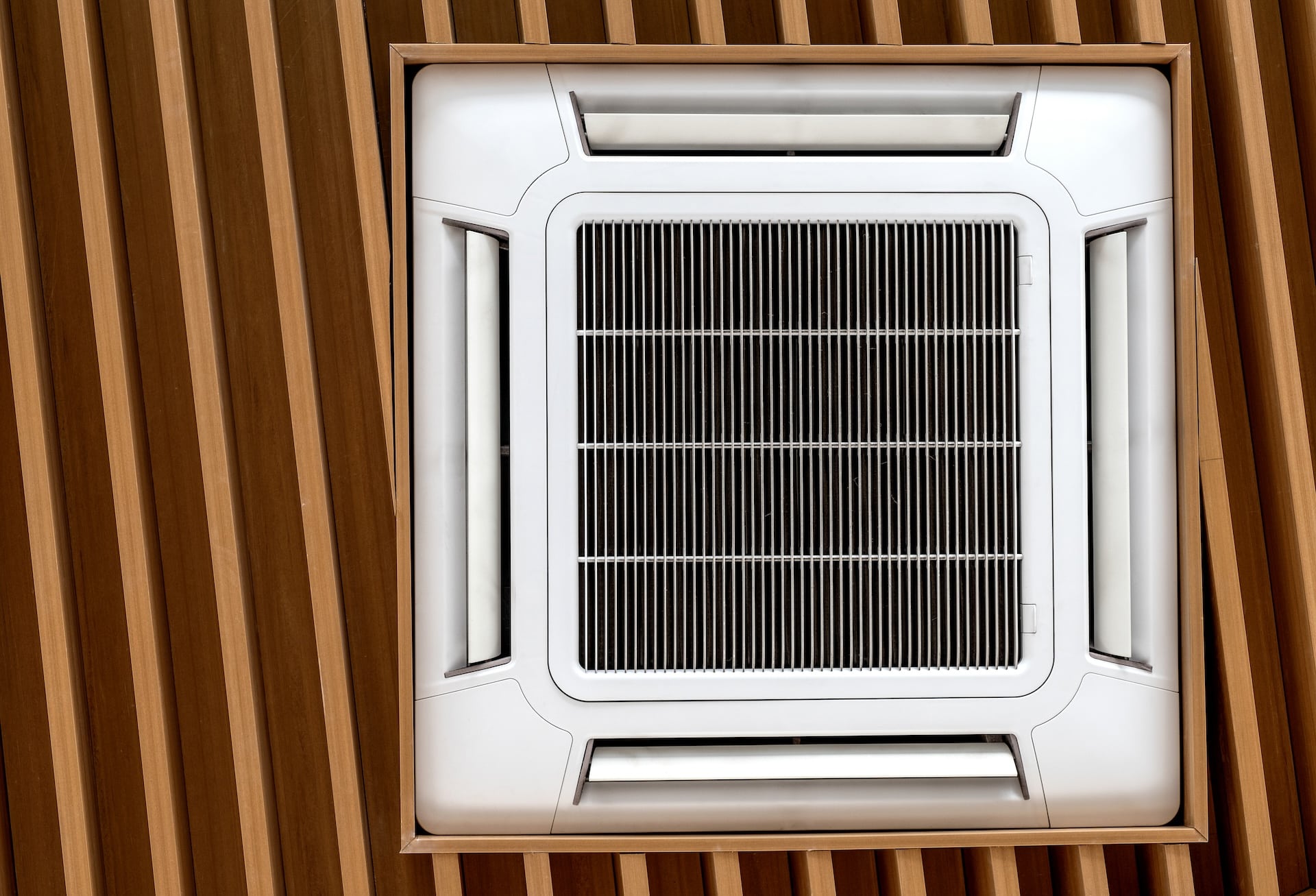 Air conditioner cassette type installed on wooden ceilings.