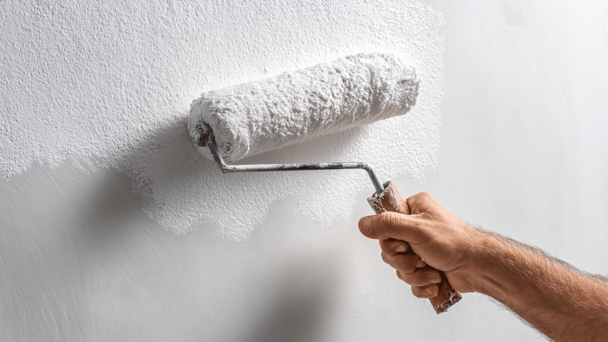 Applying primer coat evenly on wall before painting in clean setup