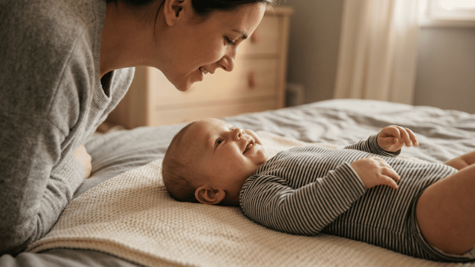 Baby smiling and cooing while interacting with parent face to face