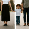 Child stands between separated parents holding their hands on split paths, representing parallel parenting after divorce.