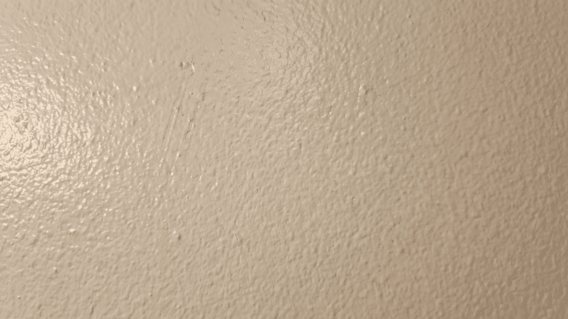Close-up of orange peel drywall texture pattern on interior wall