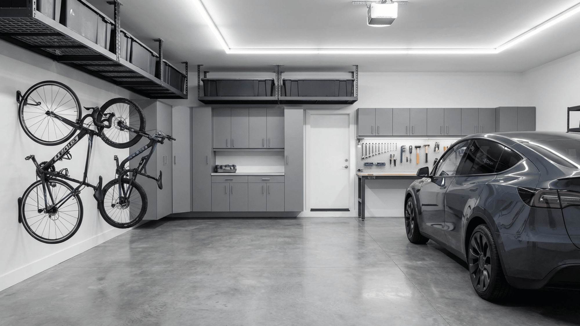 Garage with built-in cabinets, wall storage, and organized equipment.