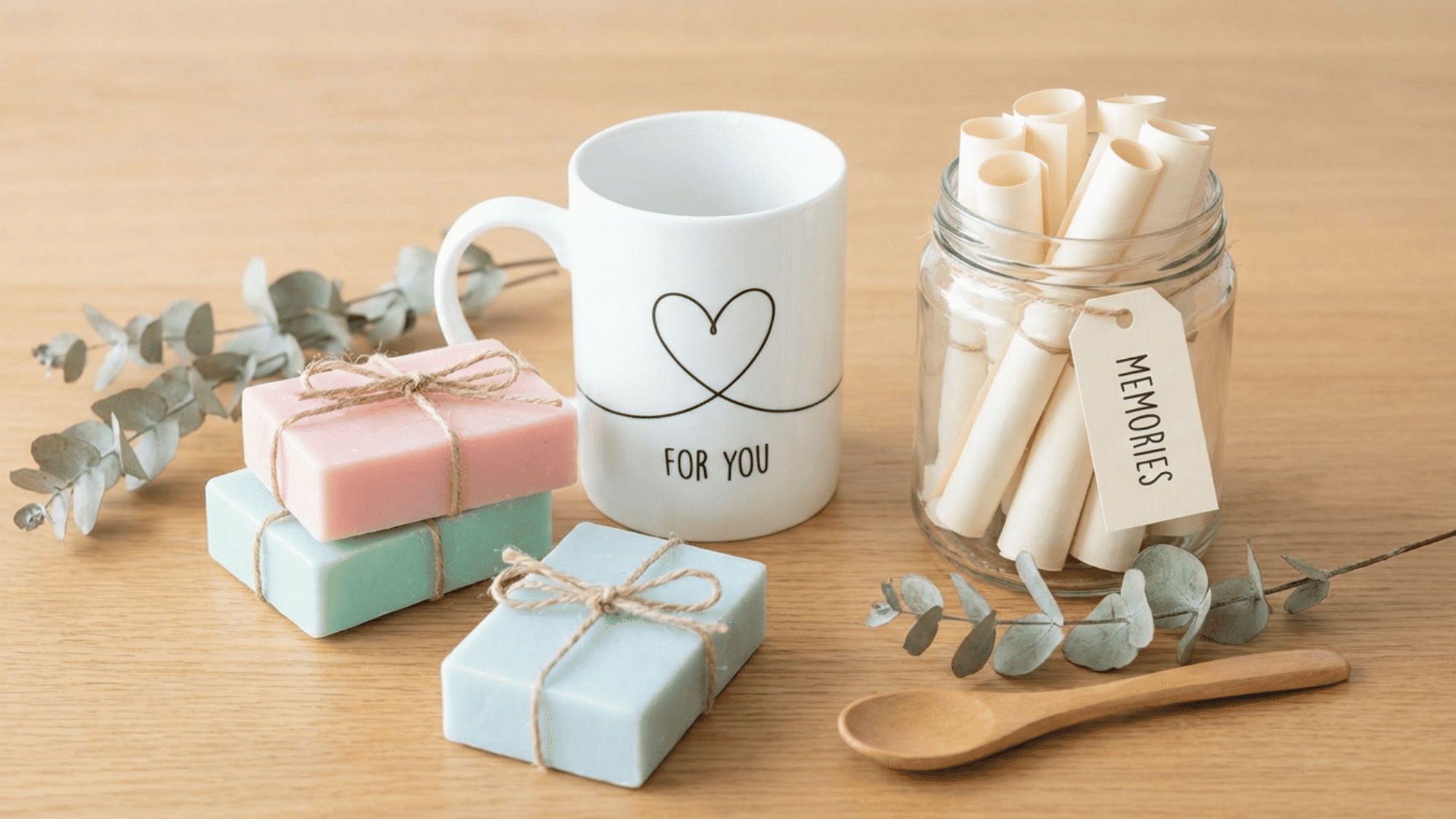Handmade gifts including soap bars, custom mug, and memory jar crafts
