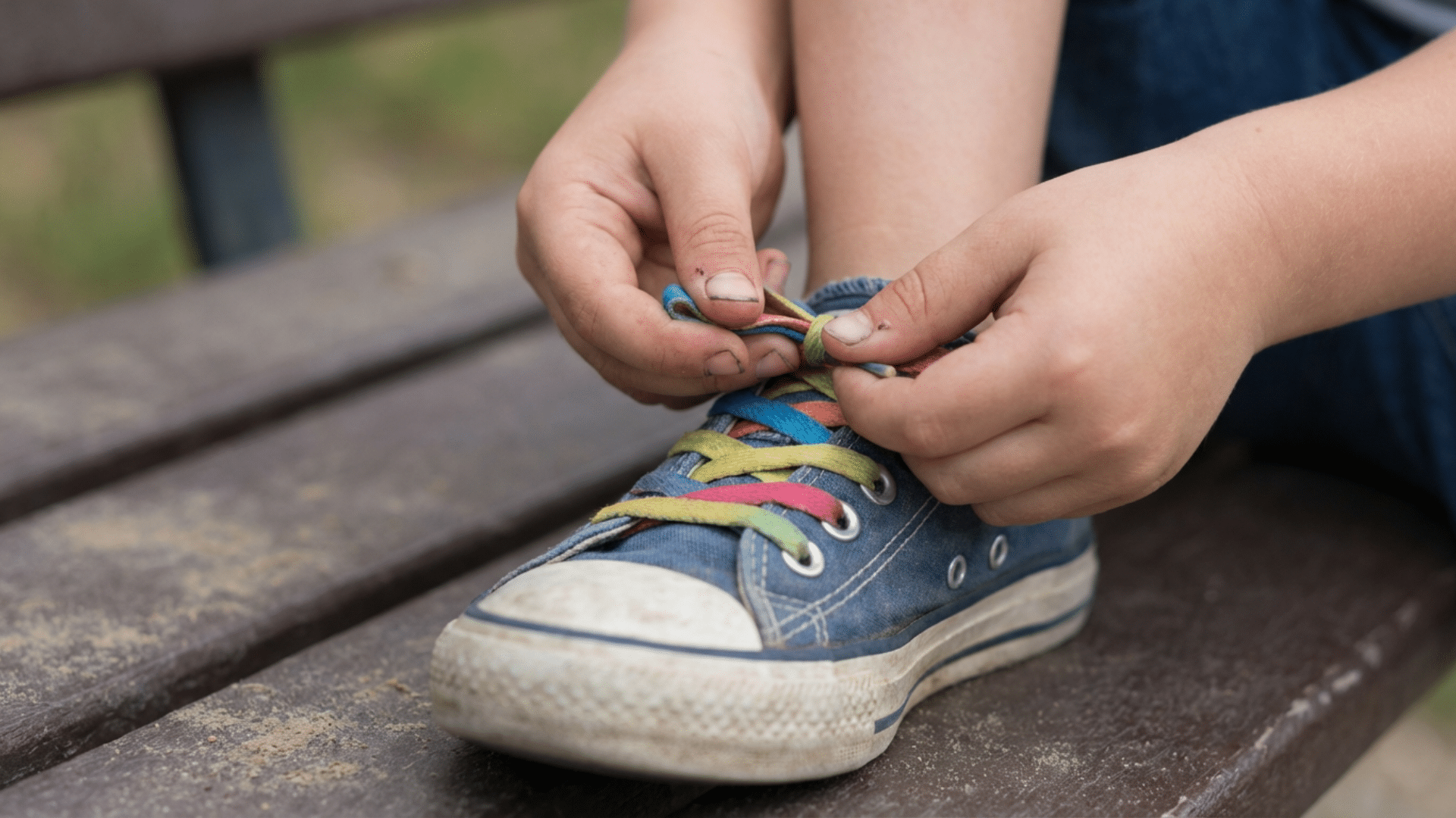 Hands demonstrating the loop swoop and pull shoe tying method