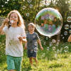 Kids blowing bubbles outdoors using homemade bubble solution