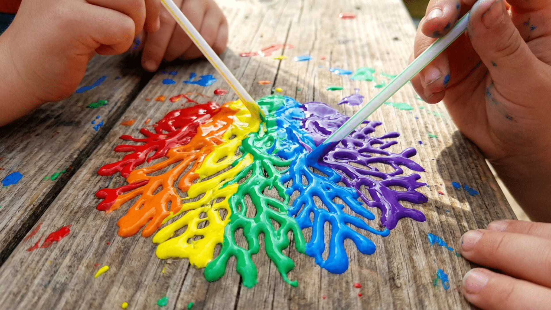 Paint spread across paper using straw blow painting technique