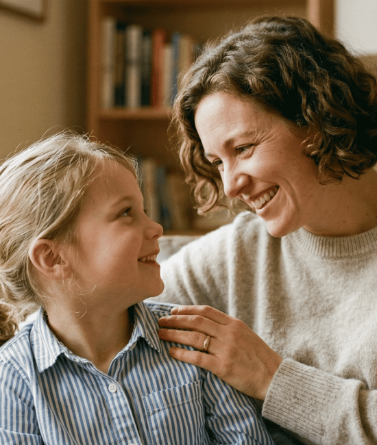Parent encouraging child with supportive smile at home.