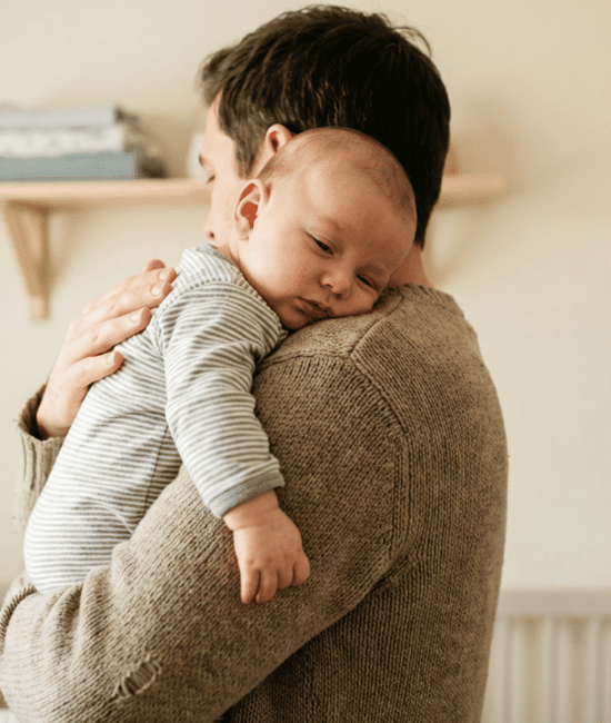 Parent gently burping baby to help relieve hiccups in a calm setting