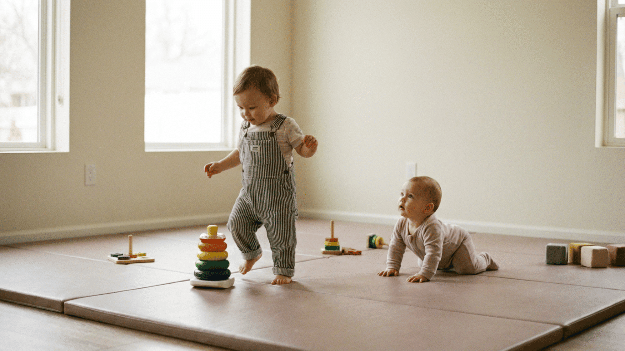 Two babies developing at different speeds, one walking and one crawling.