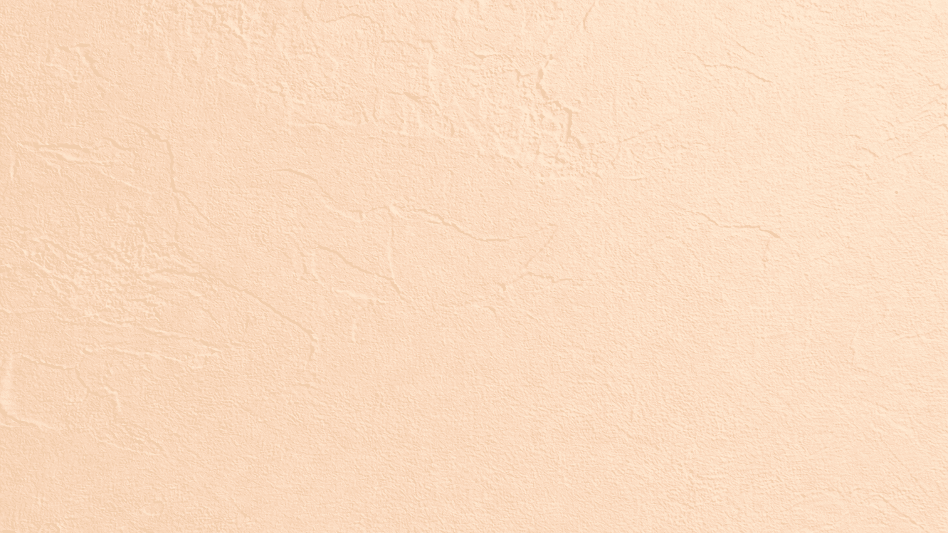 Close-up of beige Santa Fe drywall texture with partial smooth coverage, matte finish, and soft lighting highlighting subtle depth