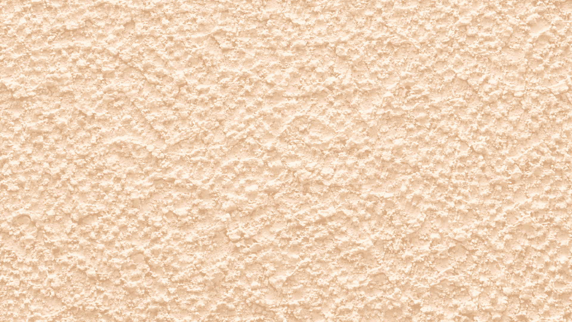 _Close-up of beige popcorn drywall texture with dense irregular bumps, matte finish, and soft lighting highlighting rough surface