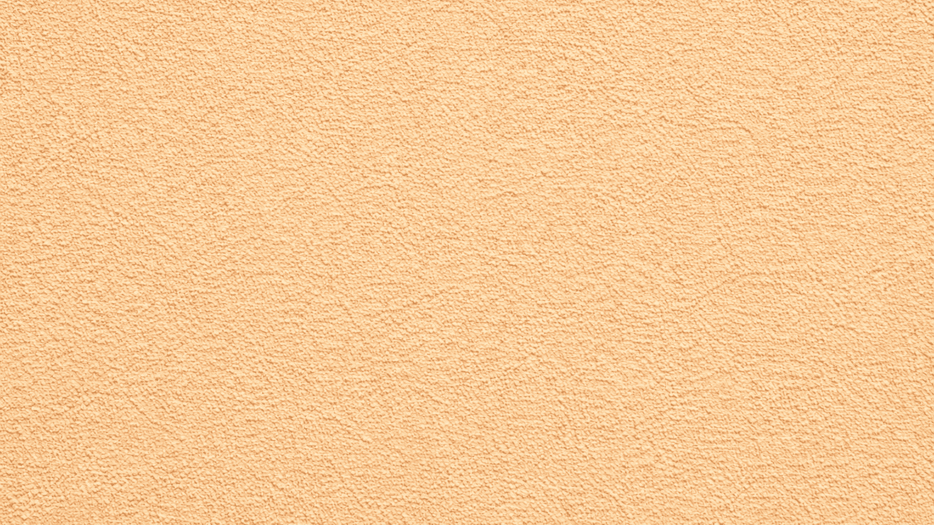 Close-up of beige sand drywall texture with fine granular surface, matte finish, and soft lighting highlighting subtle detail