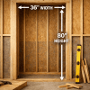 Framed wall opening labeled 36 inch width and 80 inch height for interior door, with exposed studs, header beam, and construction tools nearby