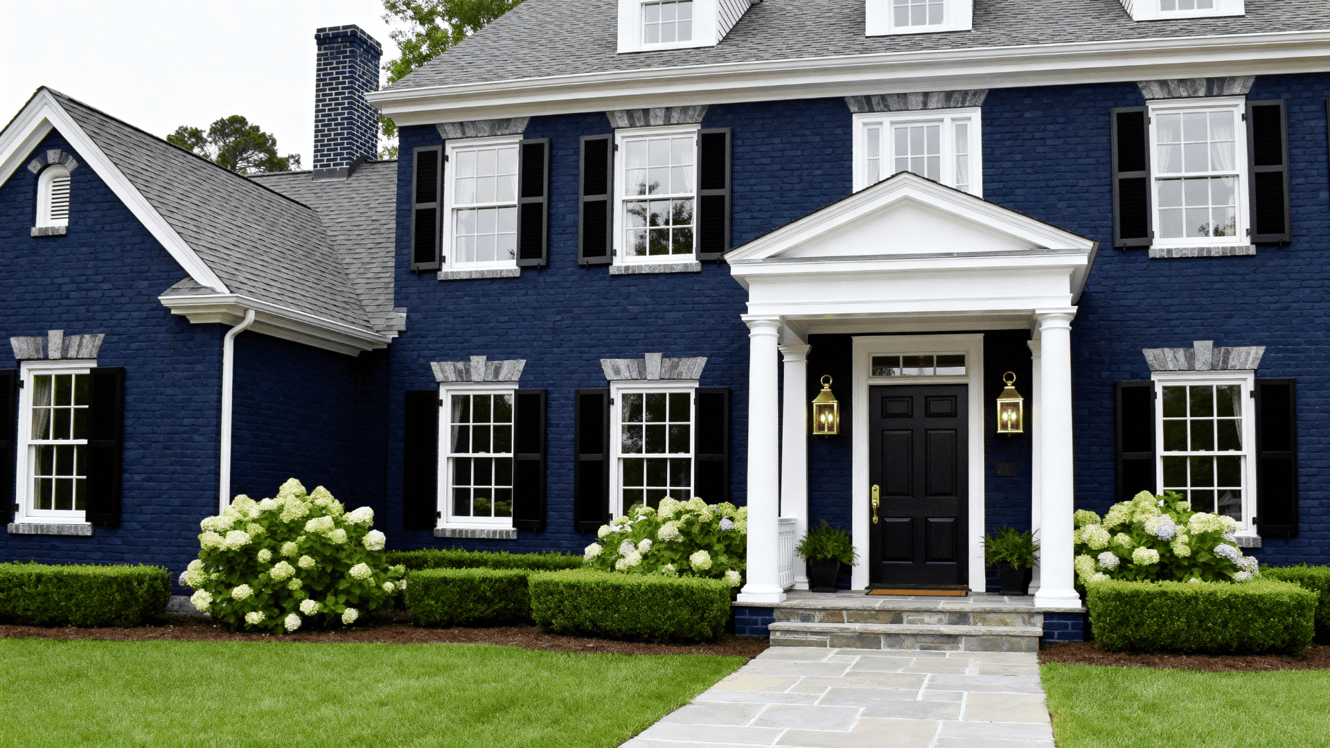 Full house exterior painted in deep navy blue brick with subtle gray undertones, creating a rich and timeless look. The entire home facade