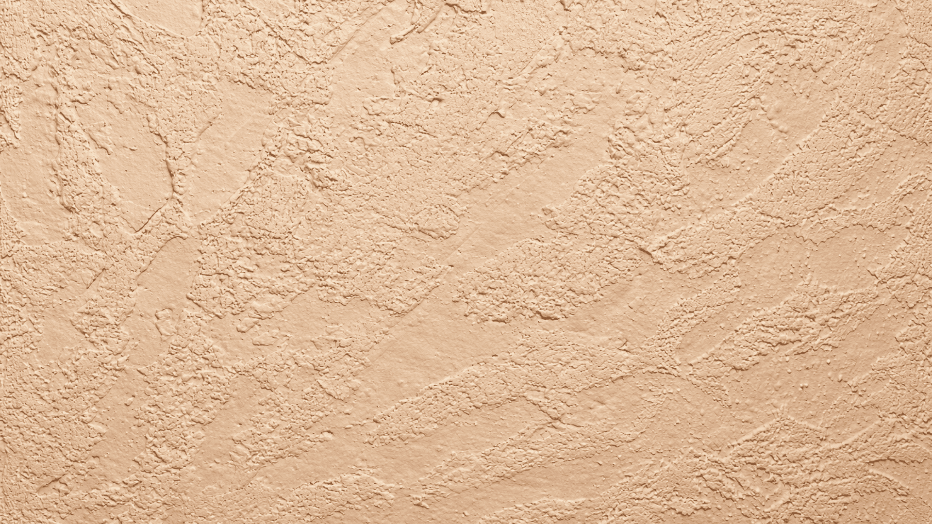 Hawk and trowel wall texture in beige stucco finish with uneven raised patterns and subtle shadows creating a handcrafted plaster look