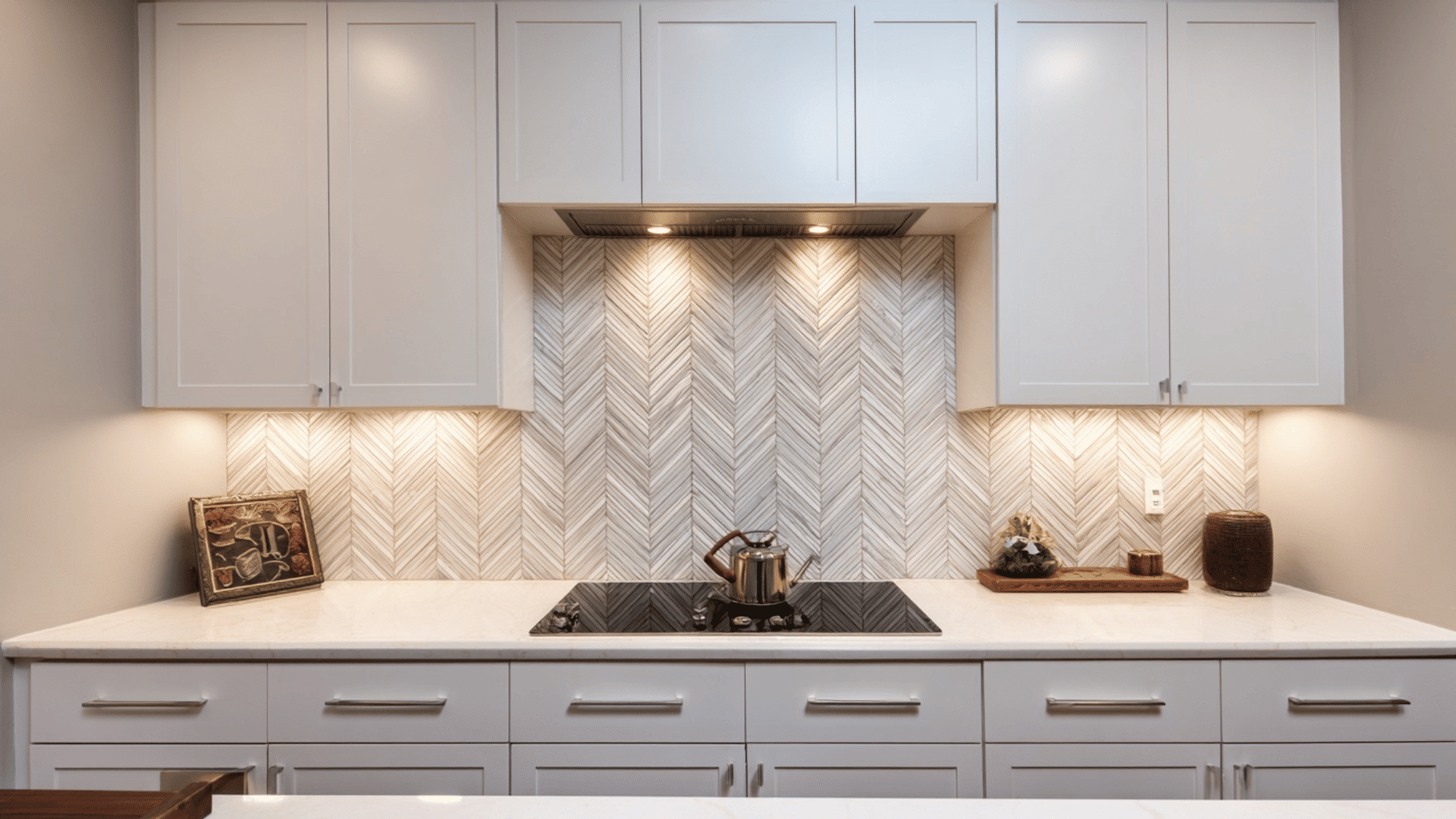 White kitchen with geometric chevron backsplash pattern