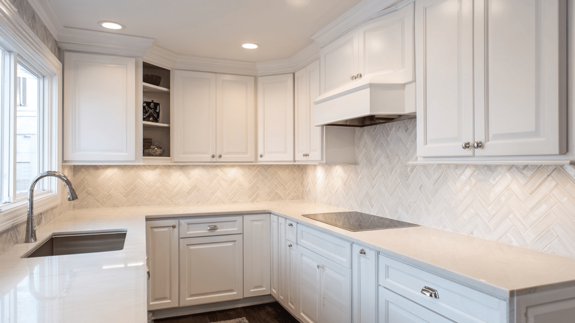 White kitchen with herringbone subway tile backsplash pattern