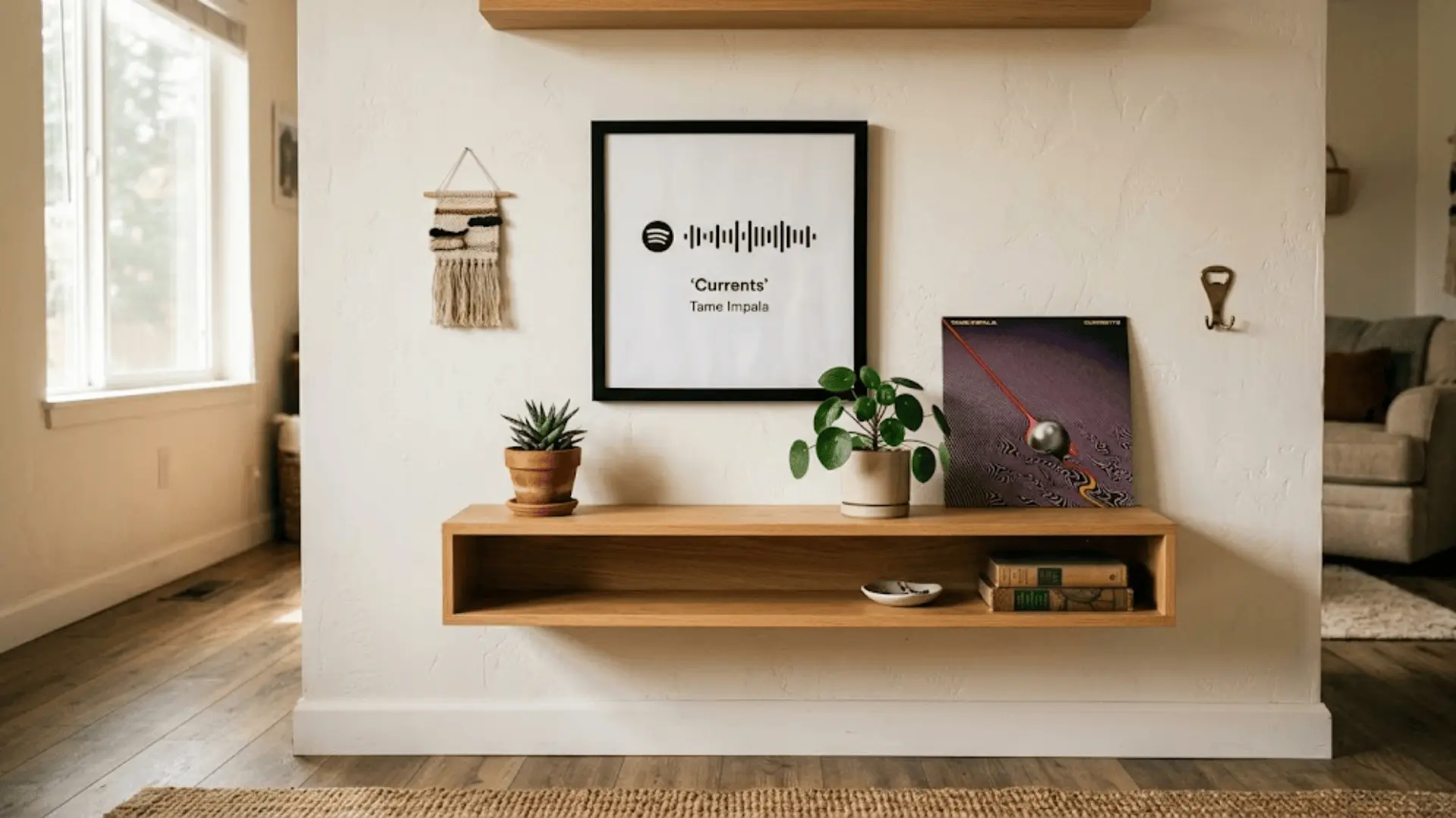 black spotify frame on white wall above wooden shelf with potted plants and a leaning vinyl record