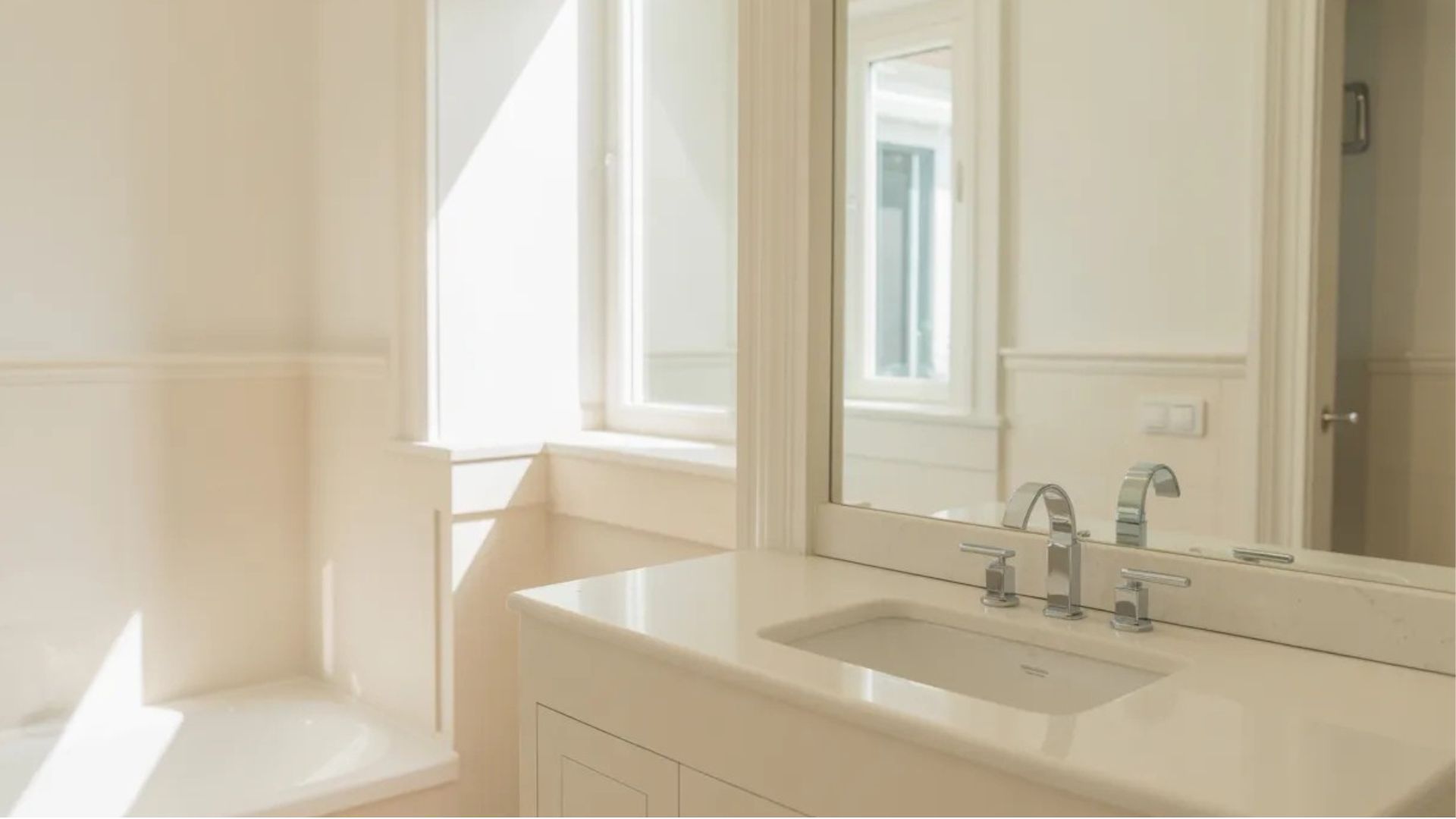 freshly painted bathroom walls in soft white color with clean modern fixtures and bright natural light creating a fresh updated look