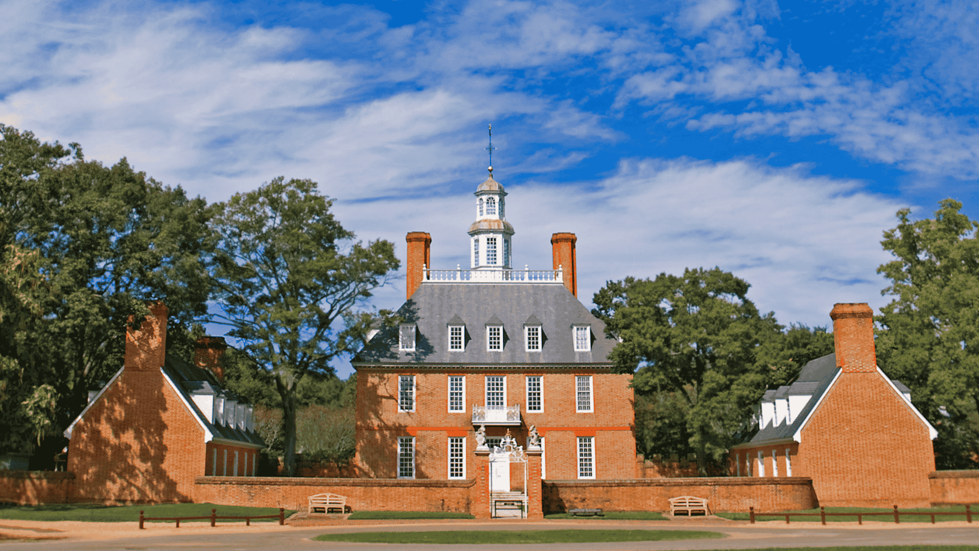 Historic Governor’s Palace in Williamsburg, red brick building under blue sky.