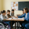 Inclusive classroom showing a child with disability learning with peers