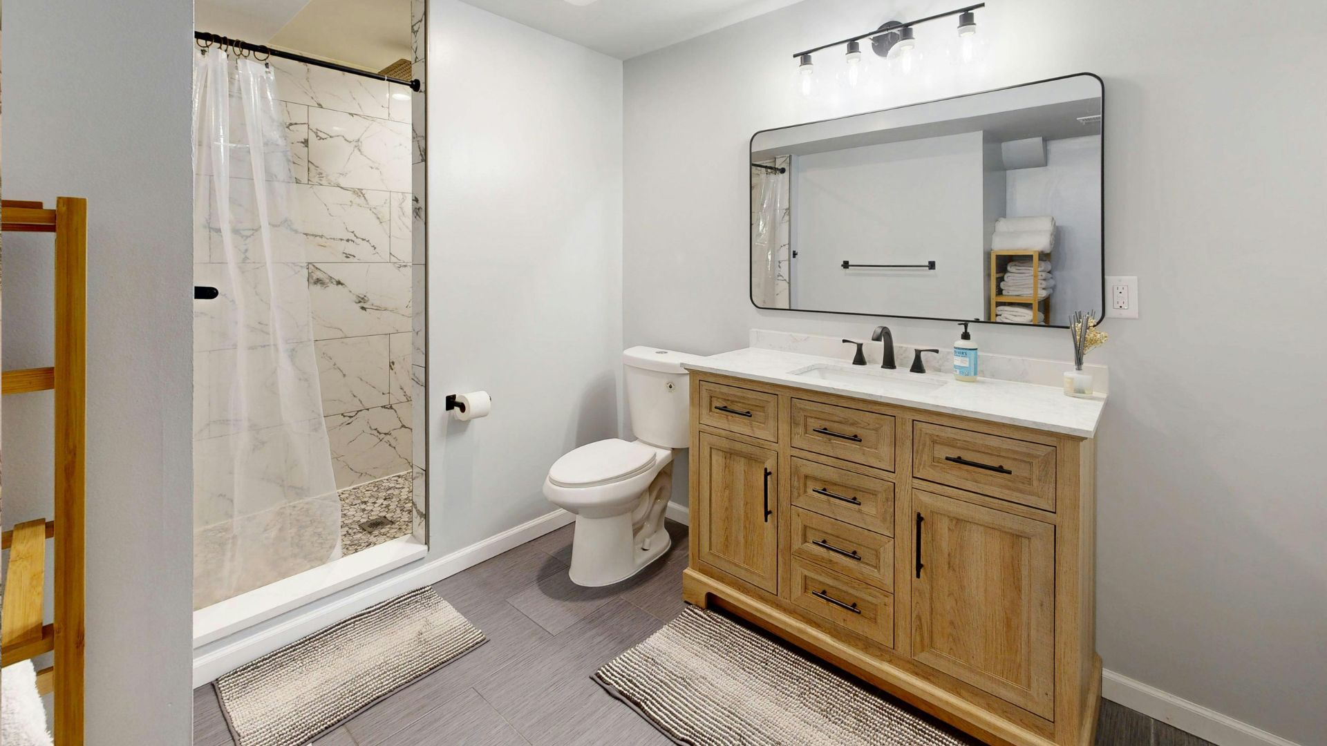 layered bathroom rugs with different textures adding warmth comfort and depth to the floor area