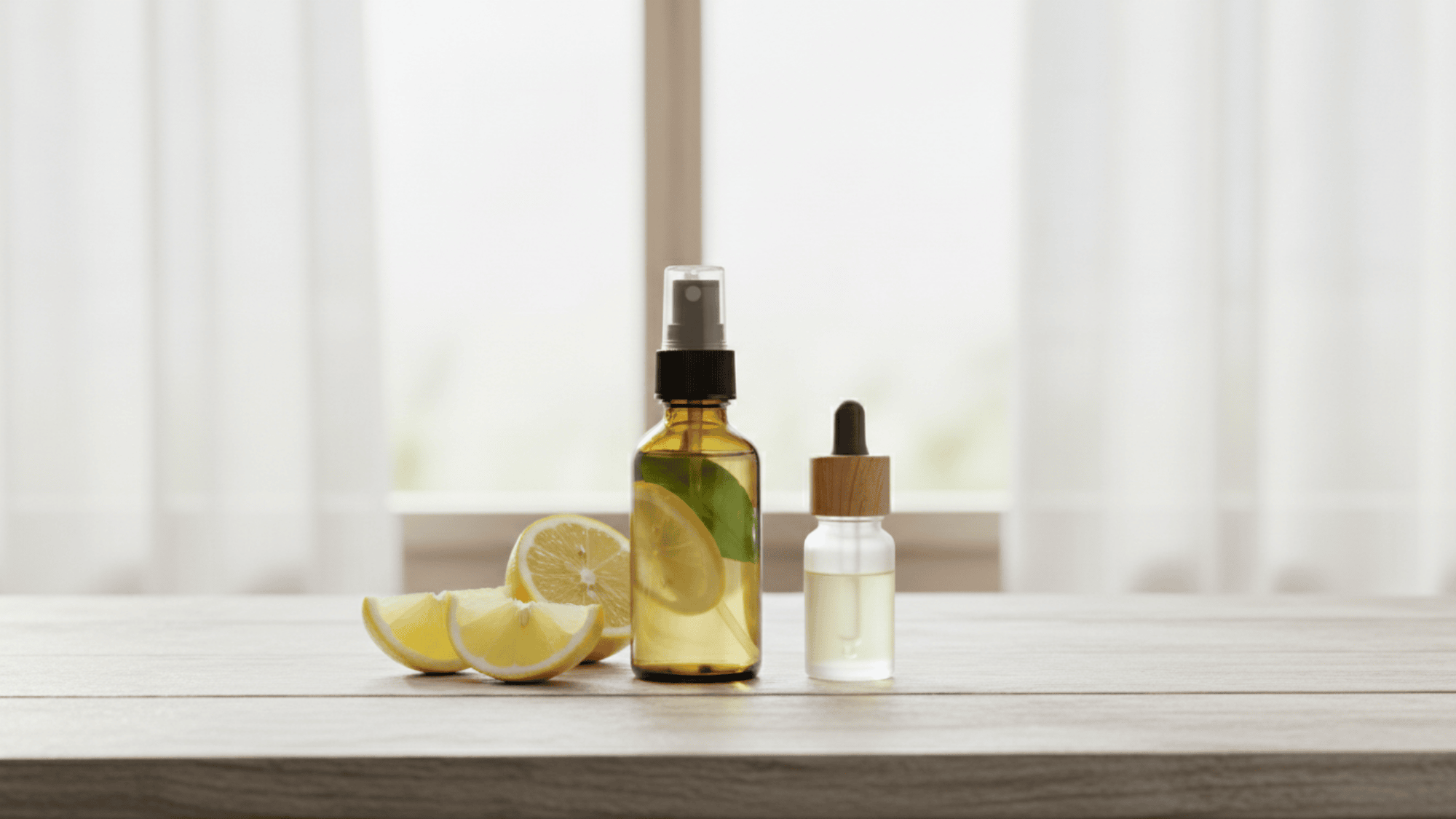 Lemon and essential oil spray bottle with fresh slices on table
