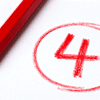 Red pencil beside circled number 4 on white paper representing a grading mark or top score