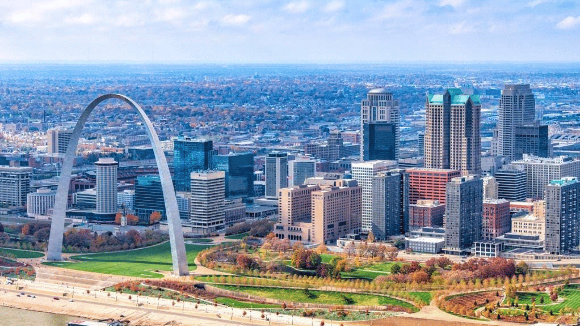 St Louis Missouri skyline with Gateway Arch and downtown buildings by Mississippi River