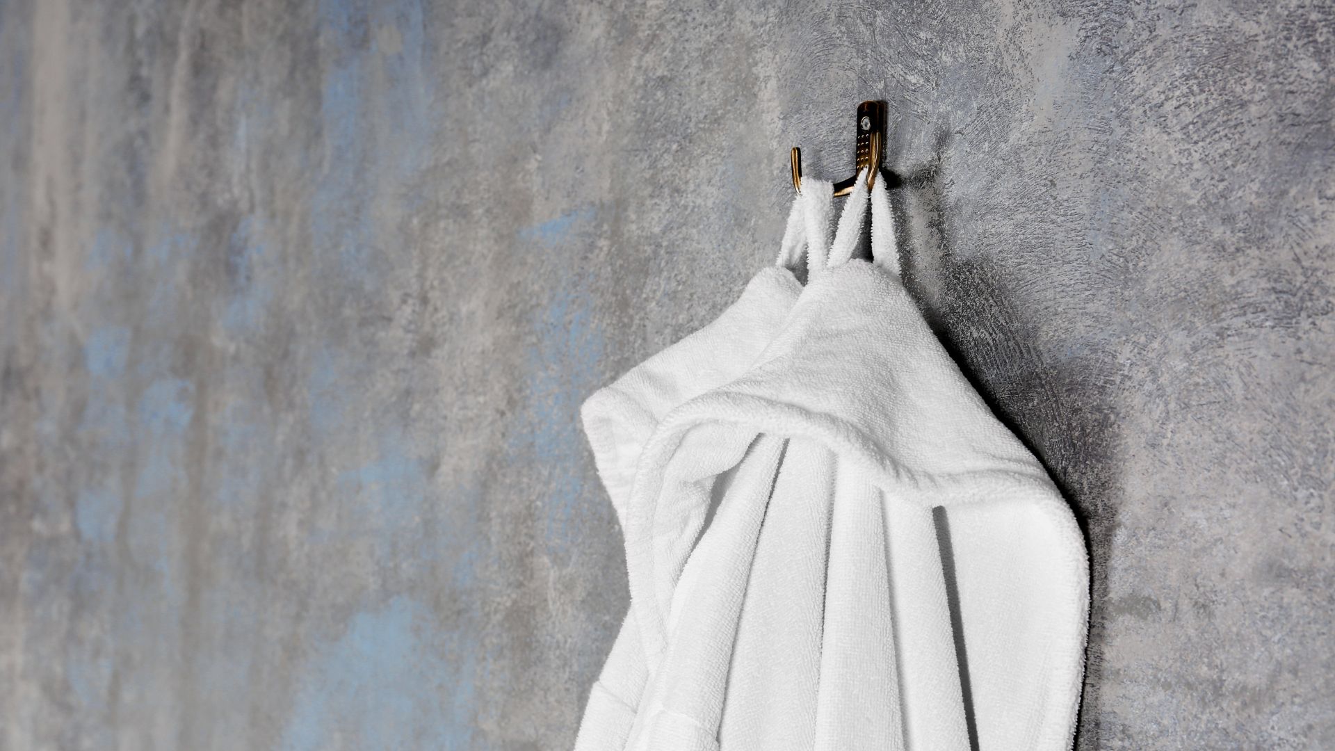 wall mounted hooks in bathroom used for hanging towels while saving space and maintaining a clean organized look