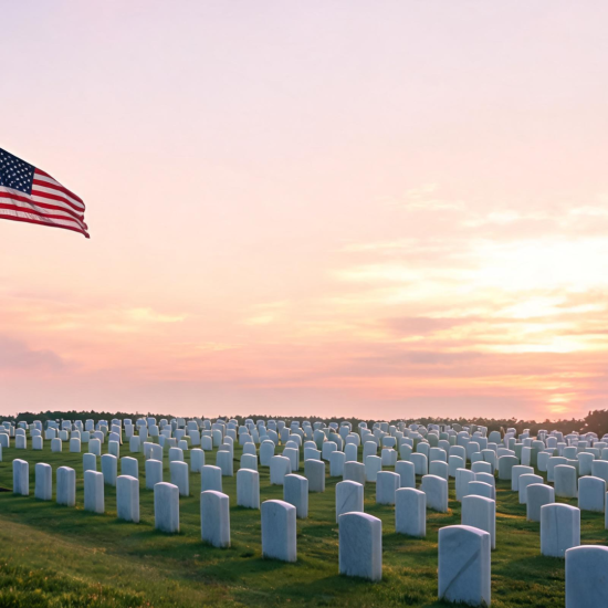 American flag at half-staff beside military graves at sunrise showing a quiet and respectful Memorial Day scene