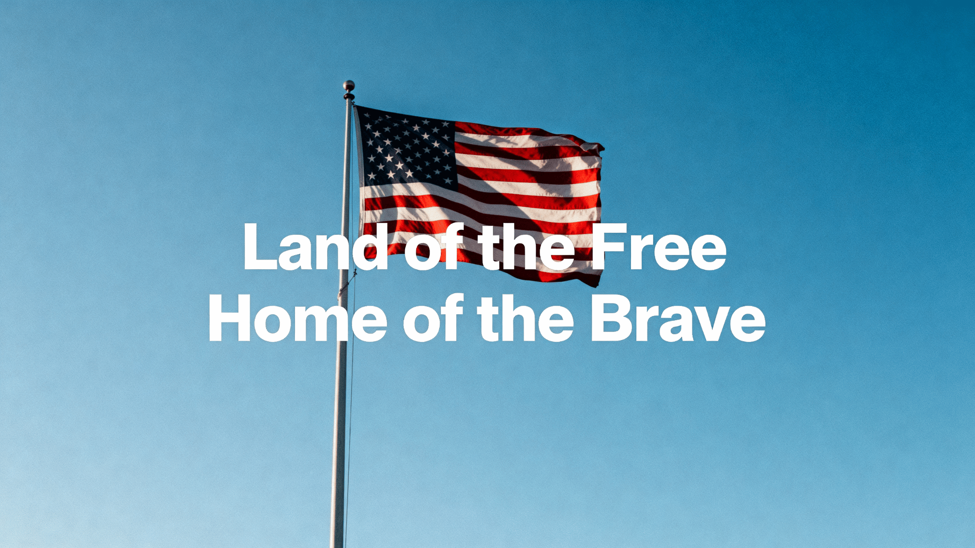 American flag waving in clear sky with space for short Memorial Day quotes. (1)