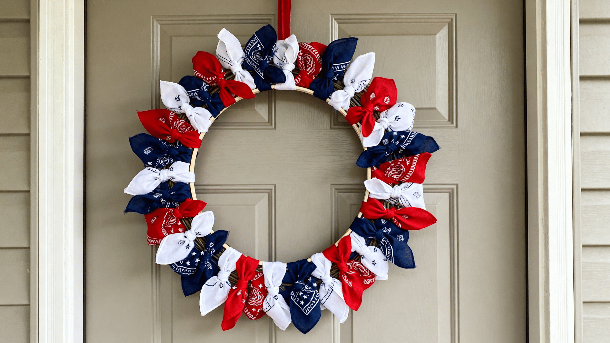 Bandana wreath with red white blue fabric tied around a frame