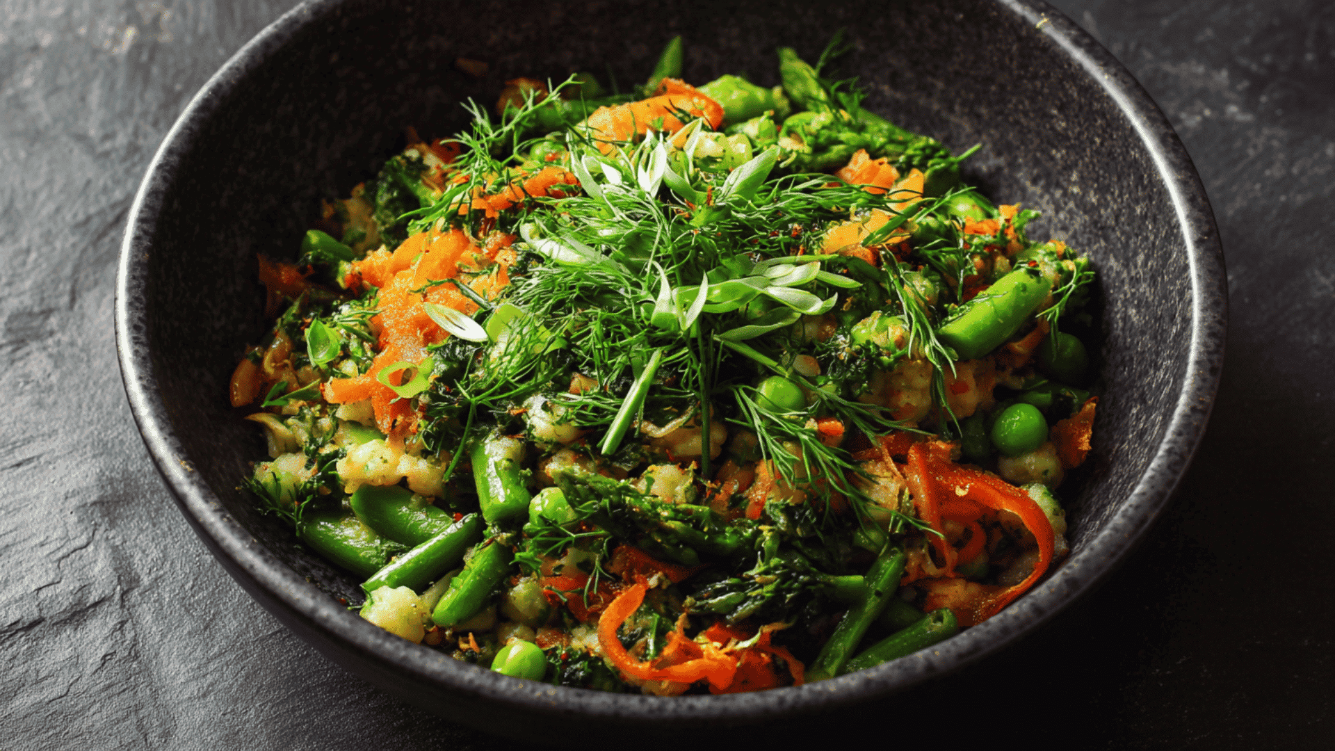 Bowl of gnocchi with fresh spring vegetables, herbs, and light sauce served for a homemade dinner. (1)