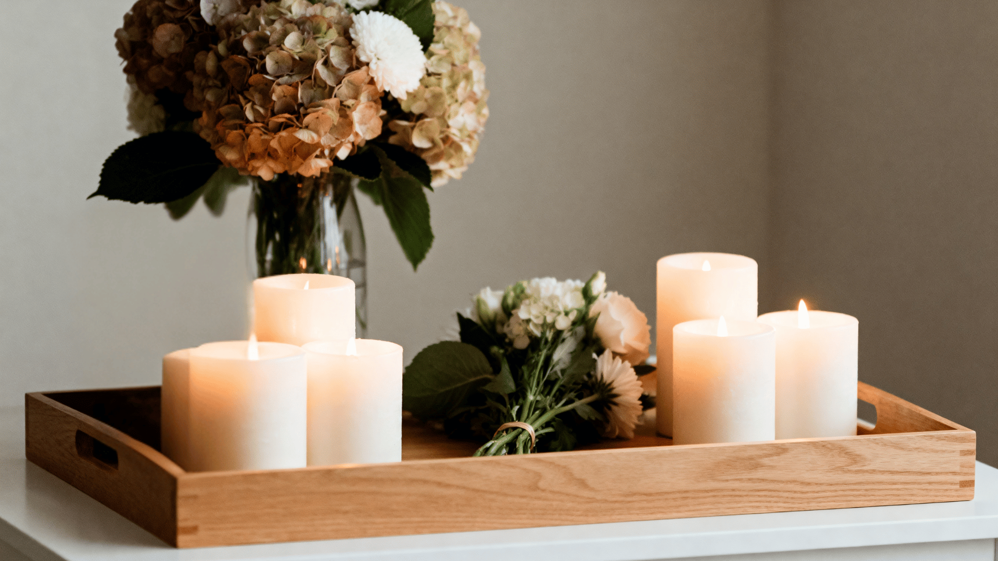 Candle display with flowers and photo on tray