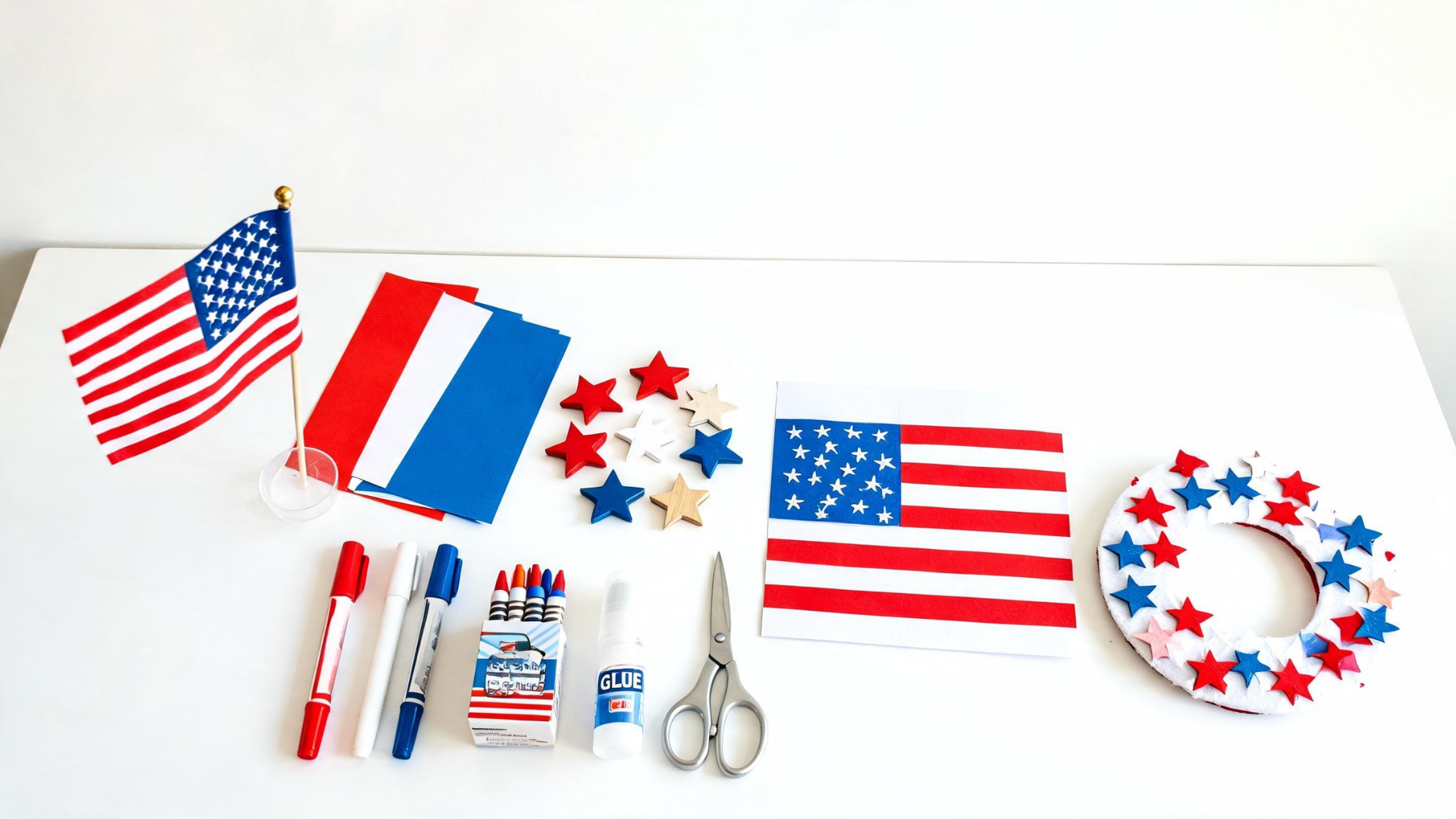 Collection of Memorial Day crafts including flags and art supplies arranged on a table