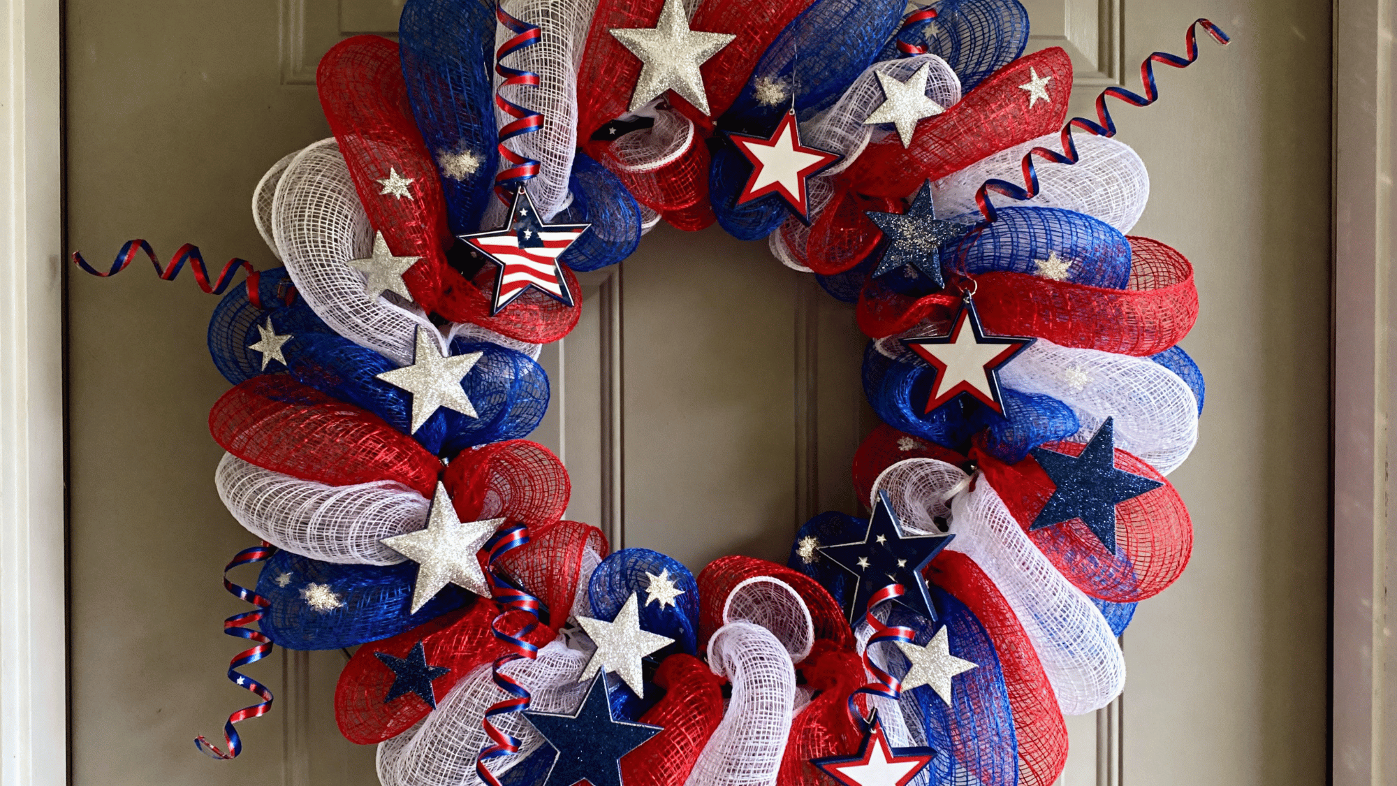 Colorful patriotic deco mesh wreath with stars and ribbon curls