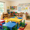 Colorful preschool classroom setup with toys, learning materials, and bright educational displays