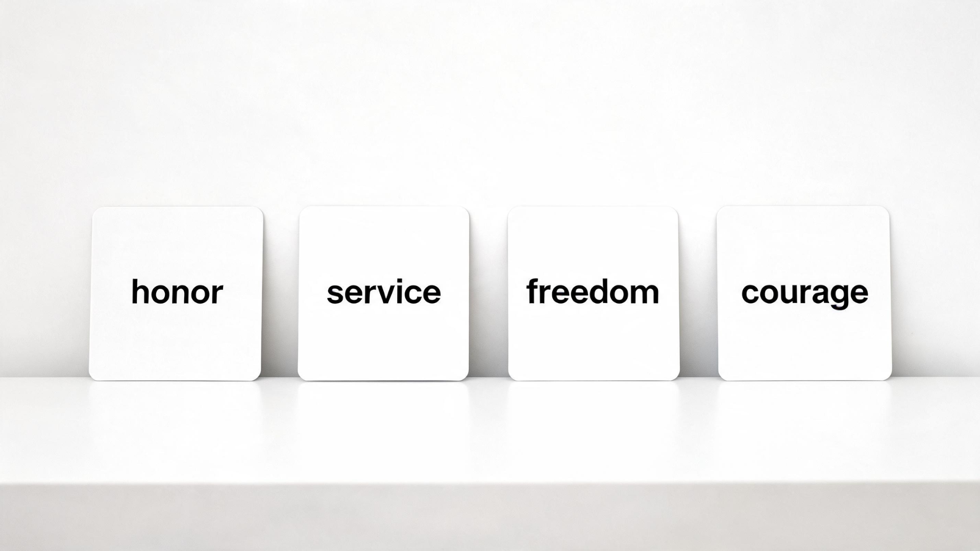 Flashcards showing words like honor, service, and freedom arranged on a clean table
