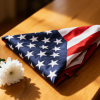 Folded flag with white flower showing remembrance and heartfelt tribute.