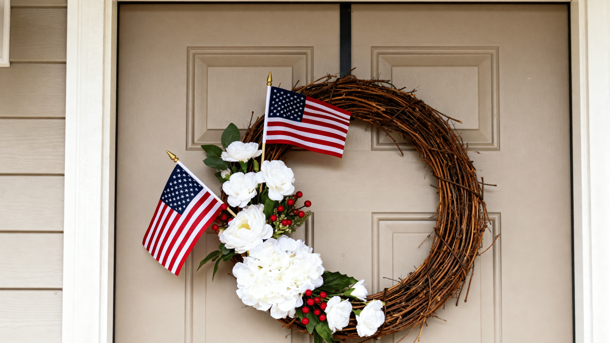 Grapevine wreath with small flags and flowers on a simple door